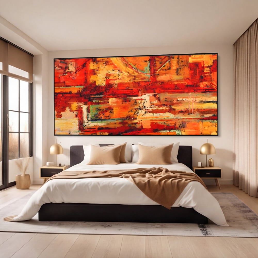 Tablou canvas cu pictura abstracta cu texturi in tonuri de rosu, in rama de aluminiu negru, pe perete intr-un dormitor